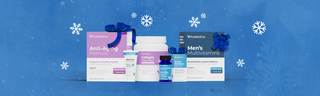 Wellness products topped with gift ribbons, against a blue background with white snowflakes.