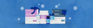 Wellness products topped with gift ribbons, against a blue background with white snowflakes.  