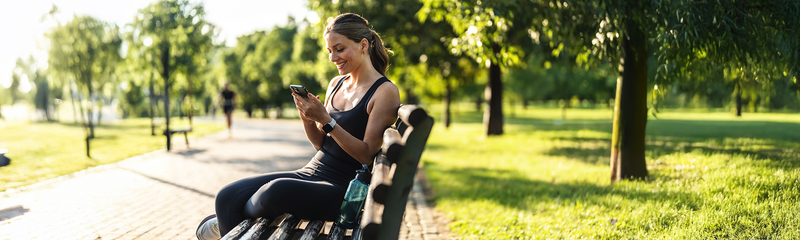 A caucasian woman in workout clothes enjoys the outdoors on a sunny spring day. 